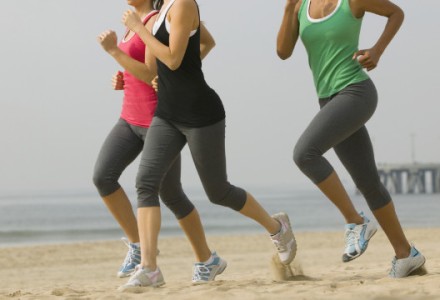 women run on the beach in california